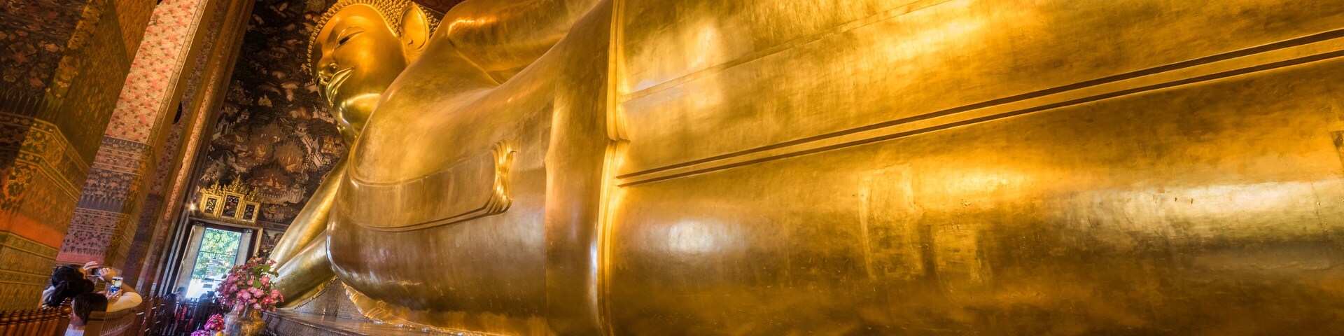Golden Statue of the Reclining Buddha at Wat Pho Buddhist Temple Complex in the Phra Nakhon District, Bangkok, Thailand. Religious Monument, Tourist Attraction, Travel Destination Concepts.