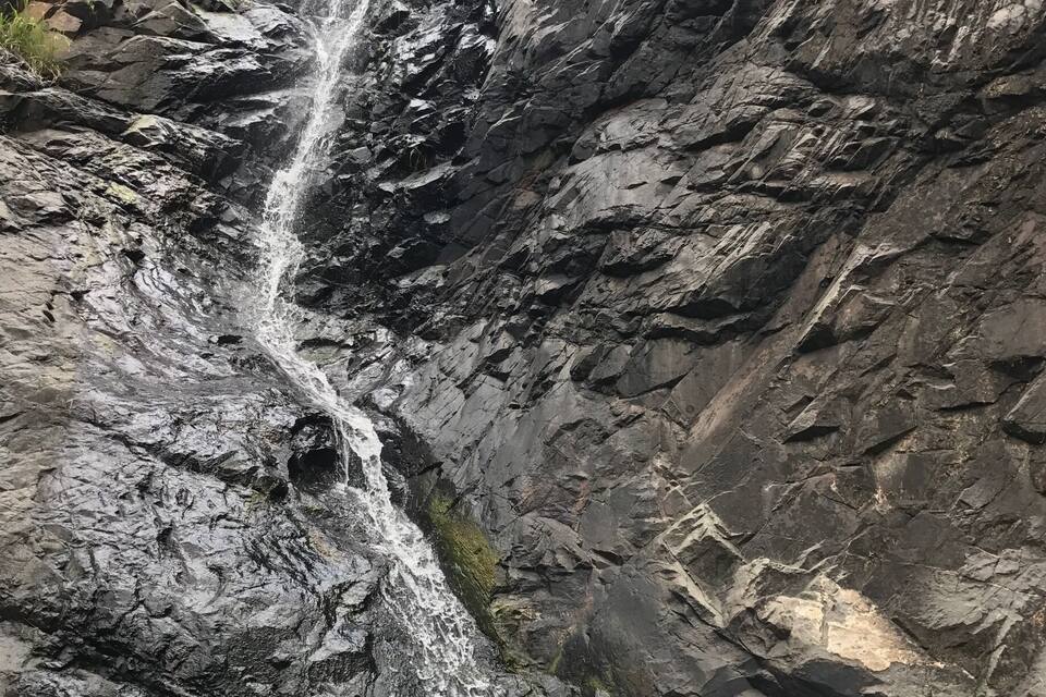 A waterfall cascading down a rocky cliff.