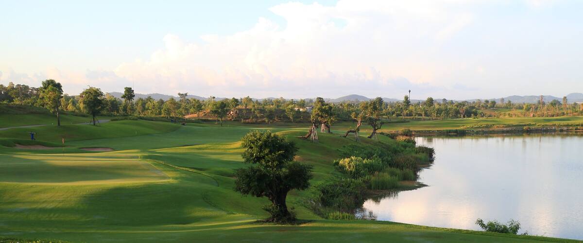 Golf course, lake, sky and green grass,Tropical golf course at sunset, Thailand