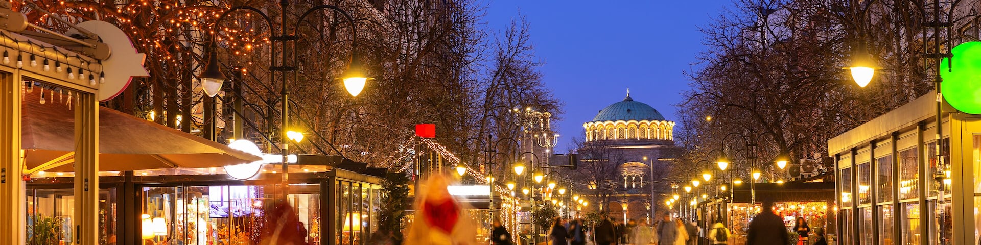 People walk along the evening busy Vitosha Boulevard in the city of Sofia, Bulgaria