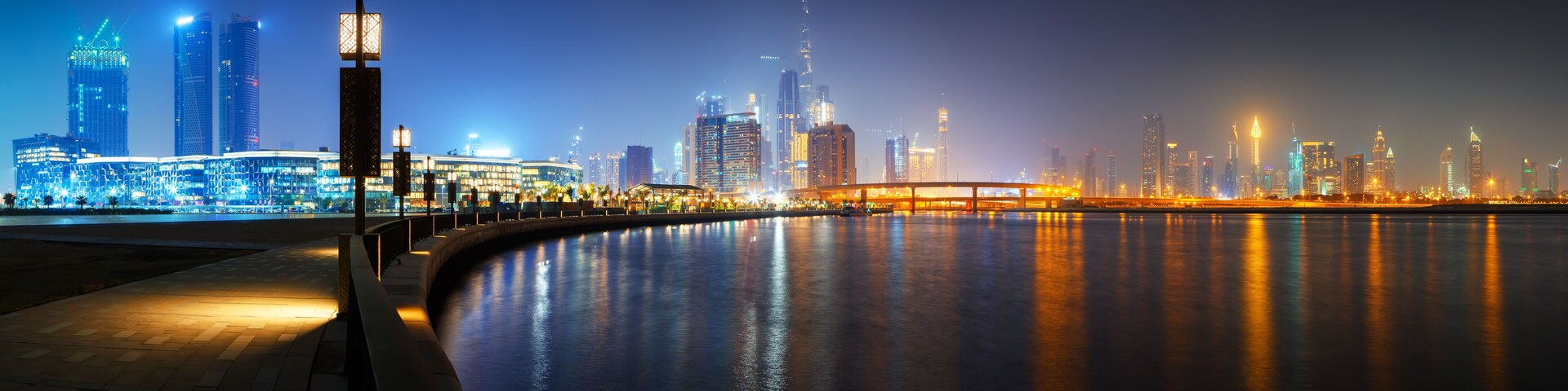 Beautiful HD panoramic view to Dubai downtown city center skyline from Design District promenade at night, United Arab Emirates