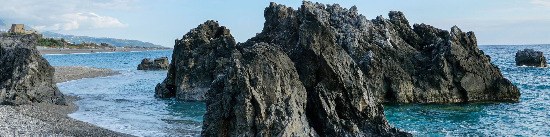 Scalea beach, Calabria region. Rocky formations at the beach. In the background, on the left, the Talao tower.