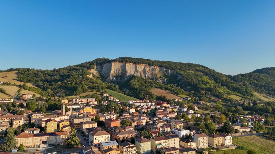 Aerial view of Lugagnano Val D'Arda, a picturesque Italian village with Pliocene clay cliffs and vineyards