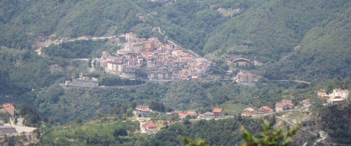 A town nestled in a valley surrounded by hills.