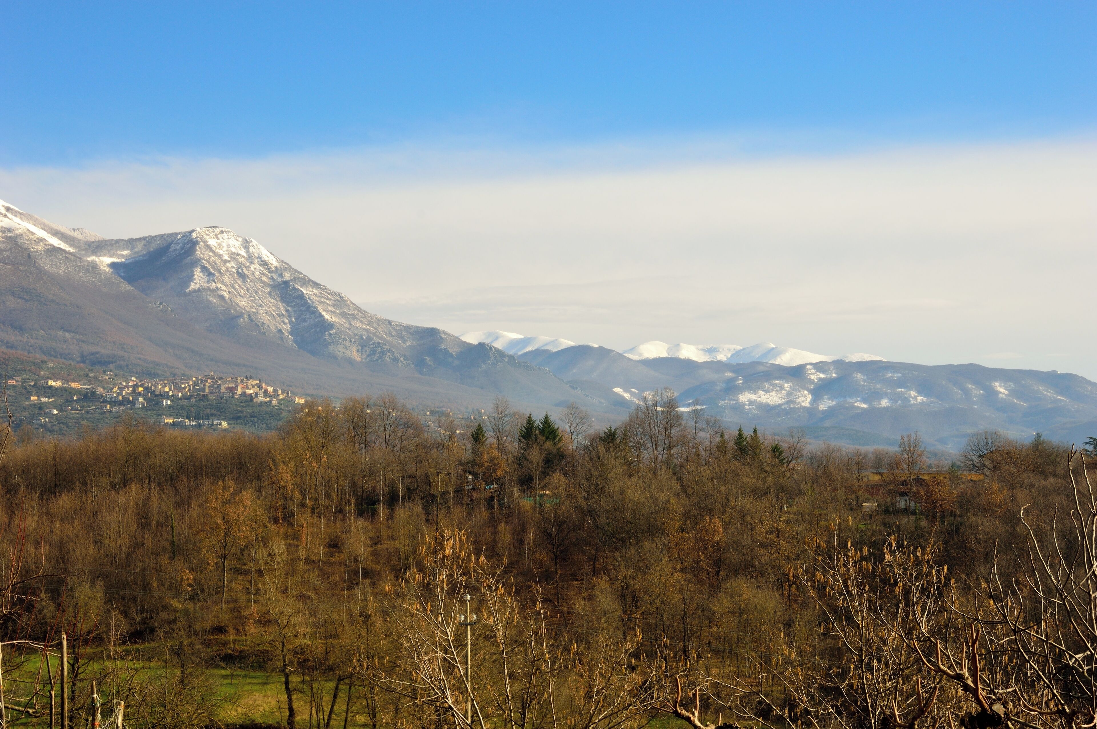 A mountainous landscape with a village in the valley.