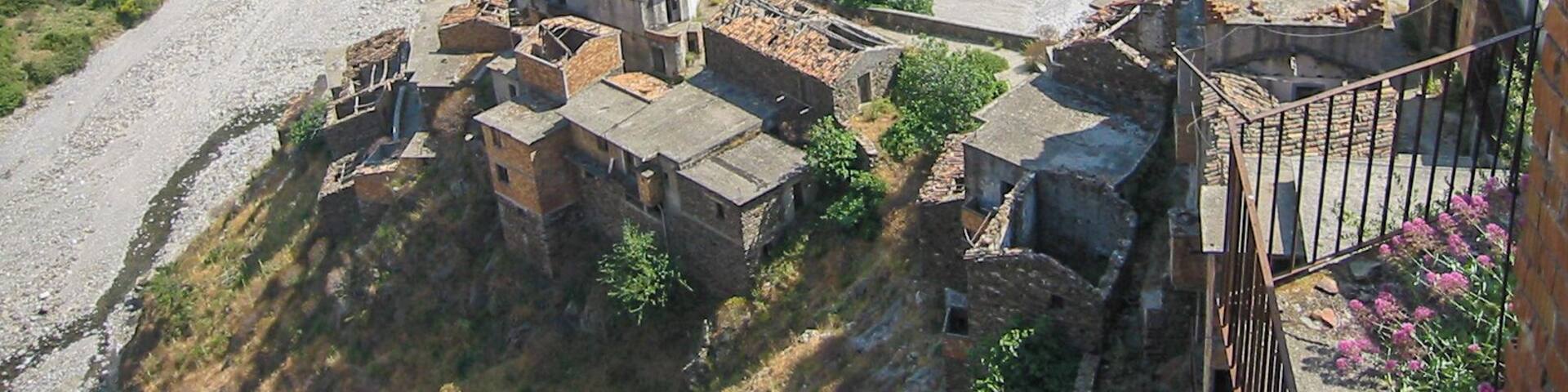Village of Roghudi vecchio in Calabria, Italy, abandoned except for a man and his father, their dog and some goats.