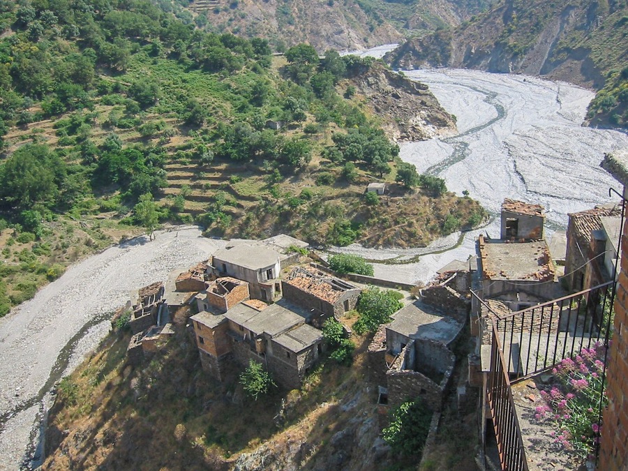 Village of Roghudi vecchio in Calabria, Italy, abandoned except for a man and his father, their dog and some goats.