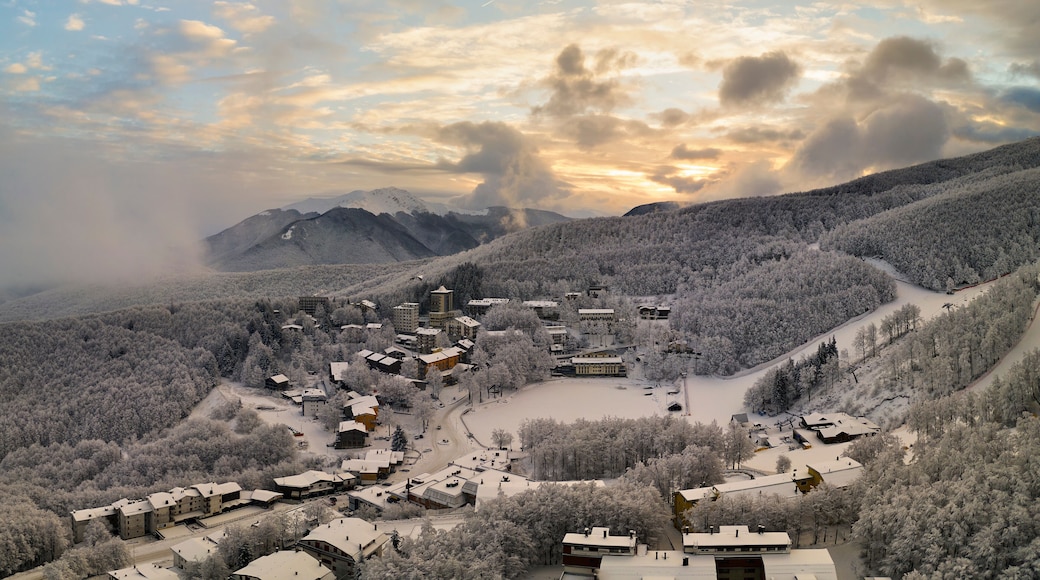 Panoramic aerial view of Cerreto Laghi town in winter season at sunrise, municipality of Ventasso, Reggio Emilia province, Emilia Romagna, Italy, Europe