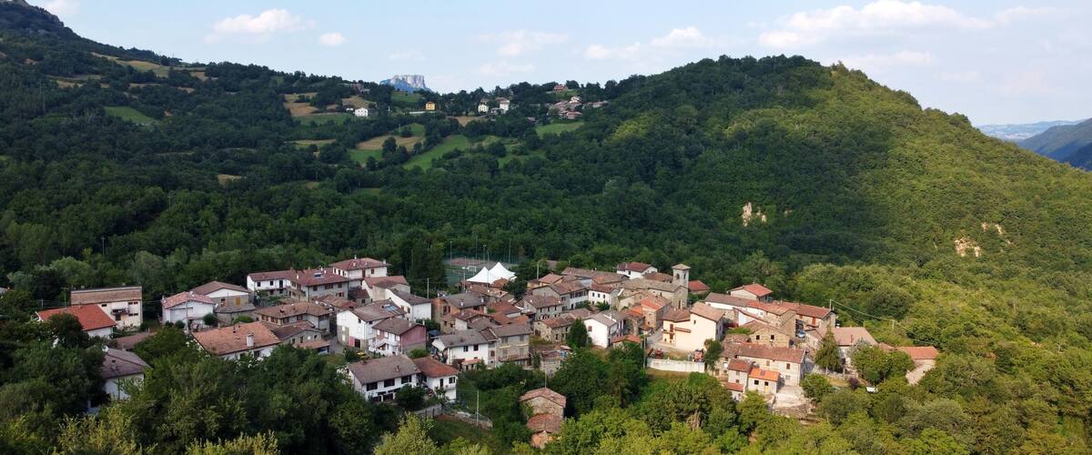 A village nestled in a valley surrounded by hills.