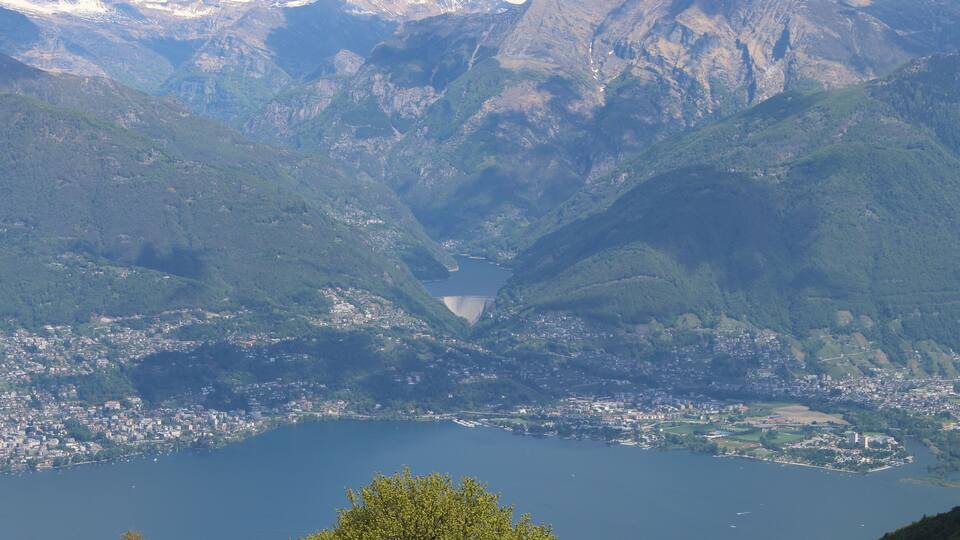 A mountainous landscape with a lake and a town at its base.