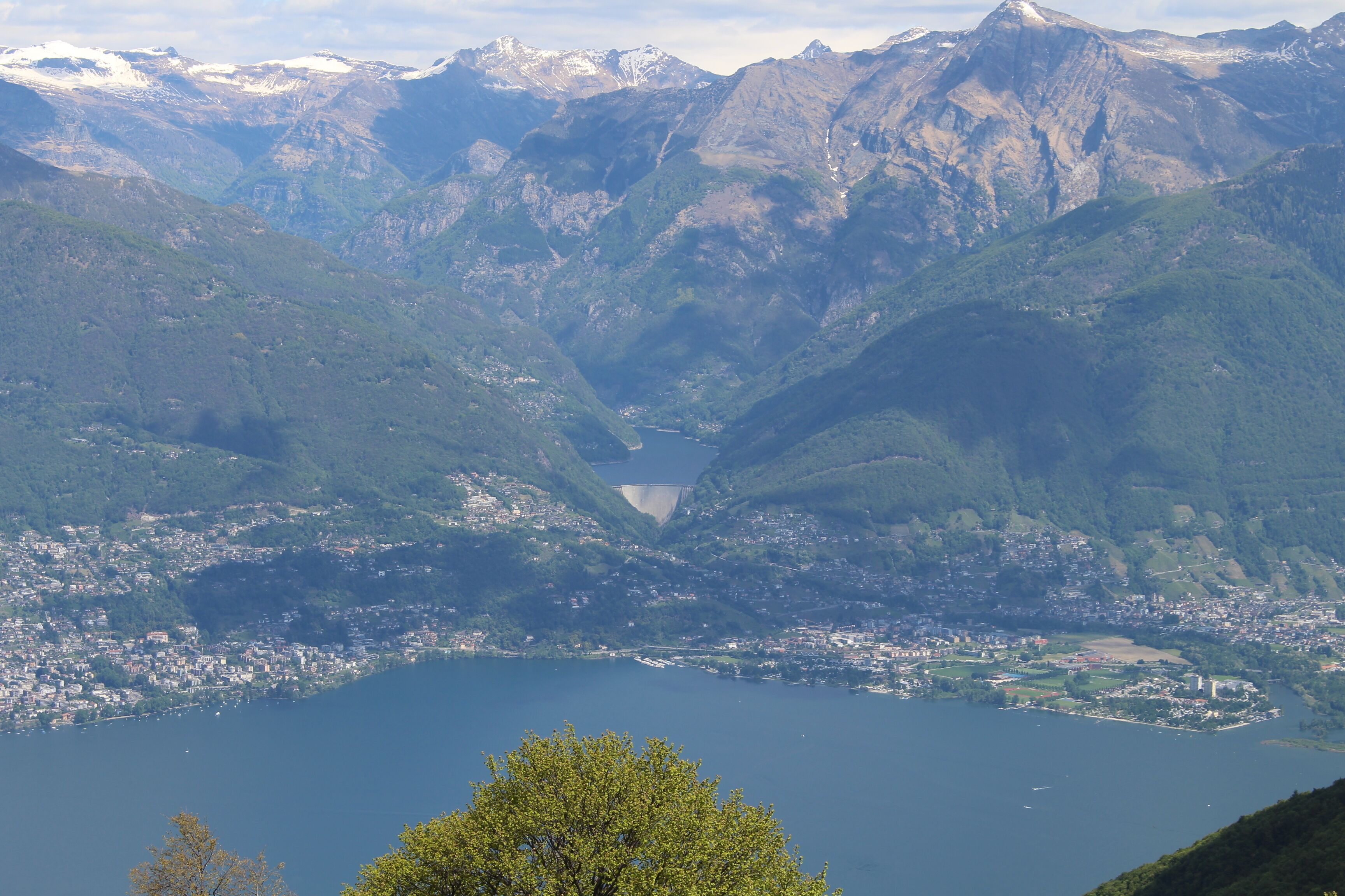 A mountainous landscape with a lake and a town at its base.