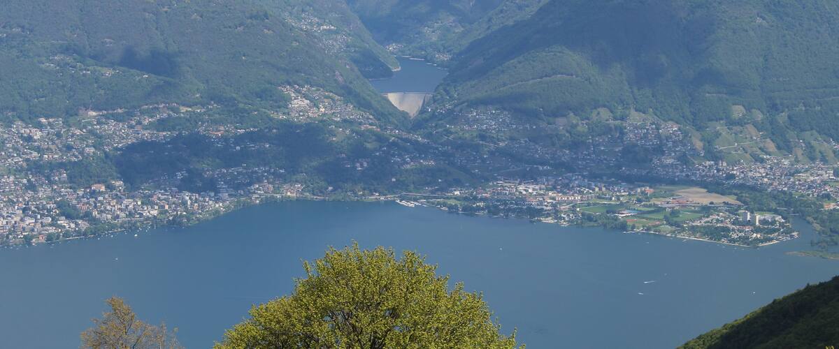 A mountainous landscape with a lake and a town at its base.