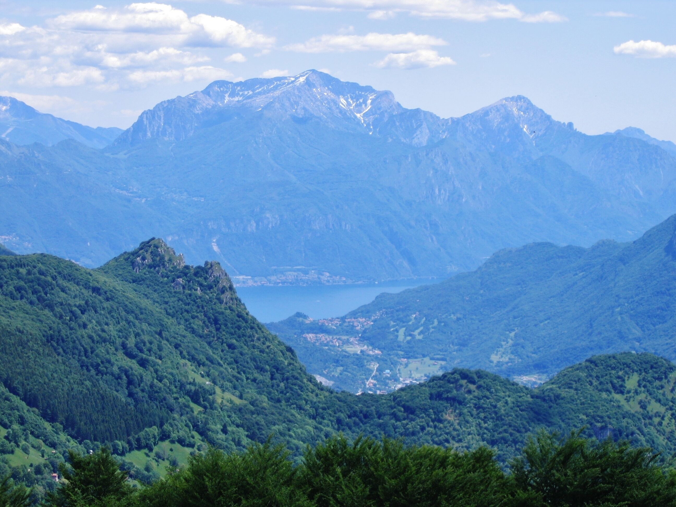 A mountainous landscape with a lake and a town in the valley.