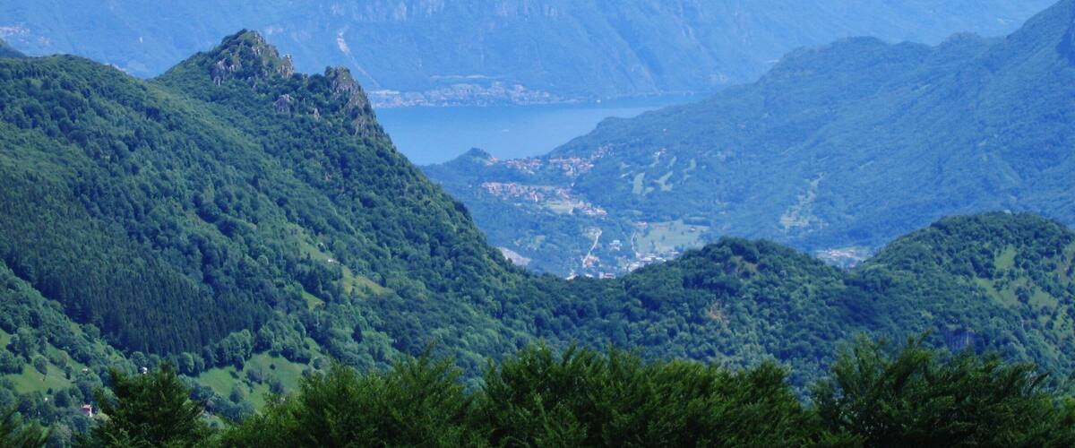 A mountainous landscape with a lake and a town in the valley.