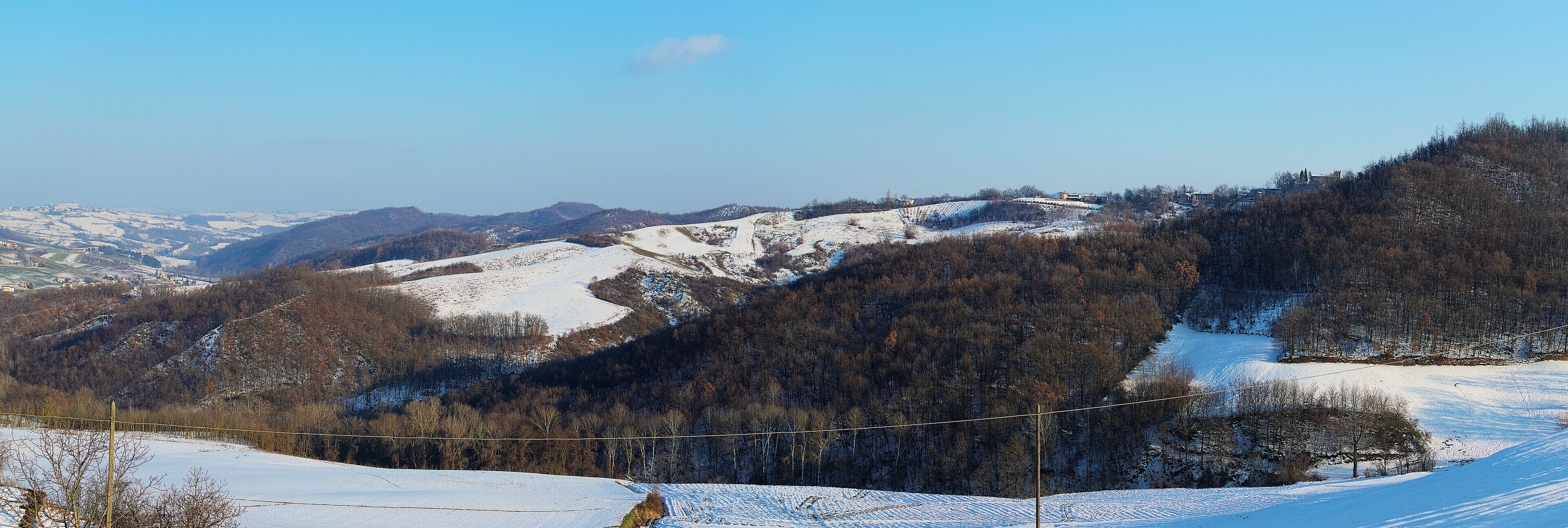 A snow-covered mountain landscape with a clear sky.