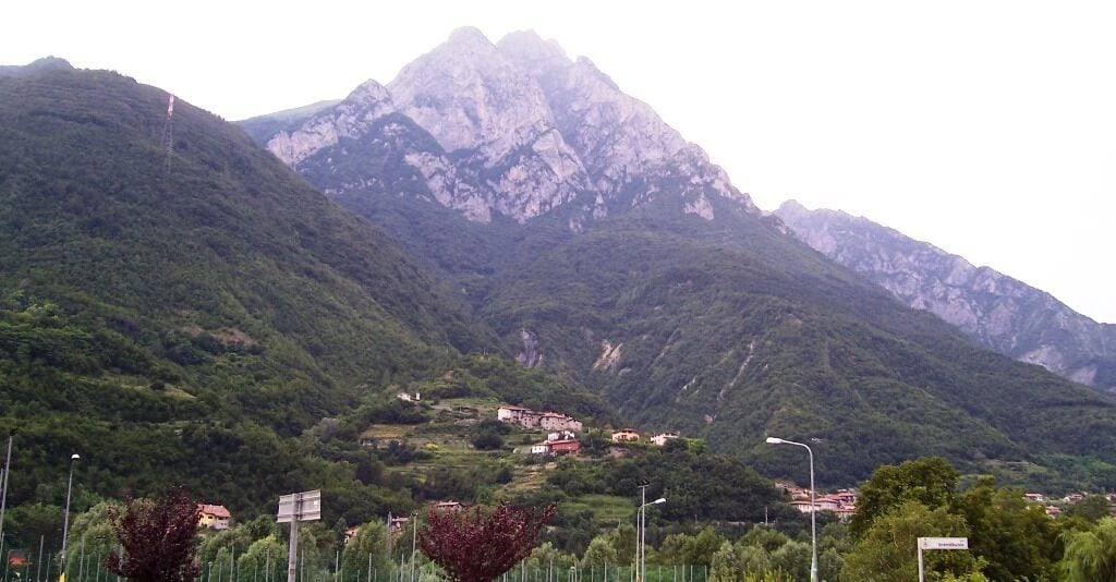 A mountainous landscape with a village nestled in the valley.
