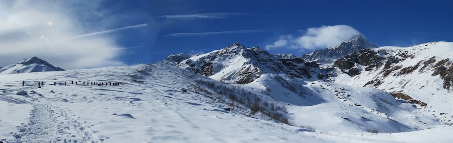 A snow-covered mountain range with a clear sky.