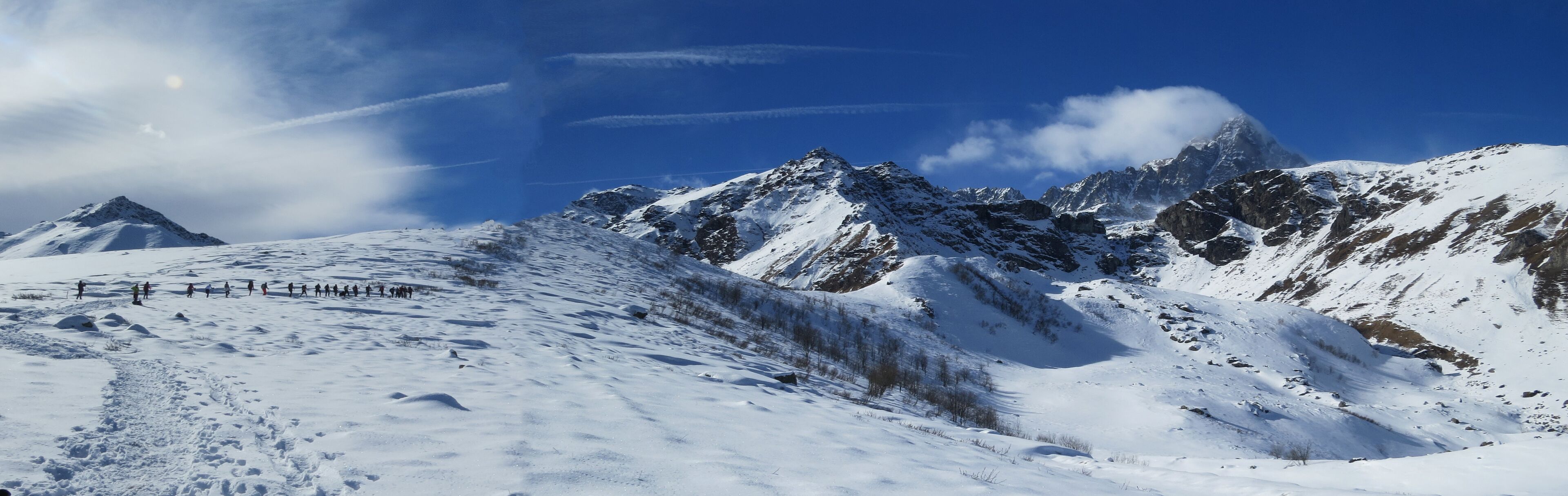 A snow-covered mountain range with a clear sky.