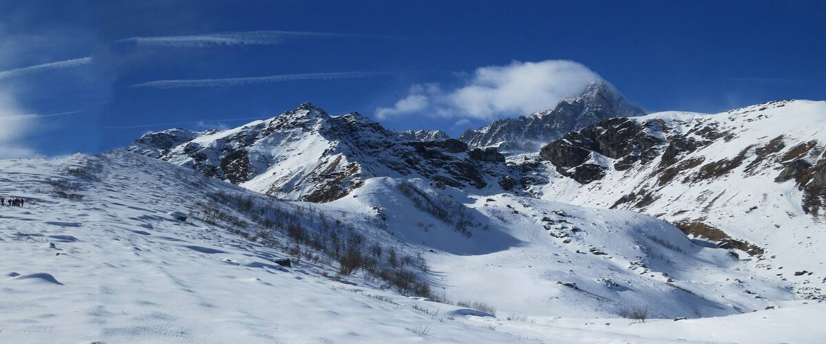 A snow-covered mountain range with a clear sky.