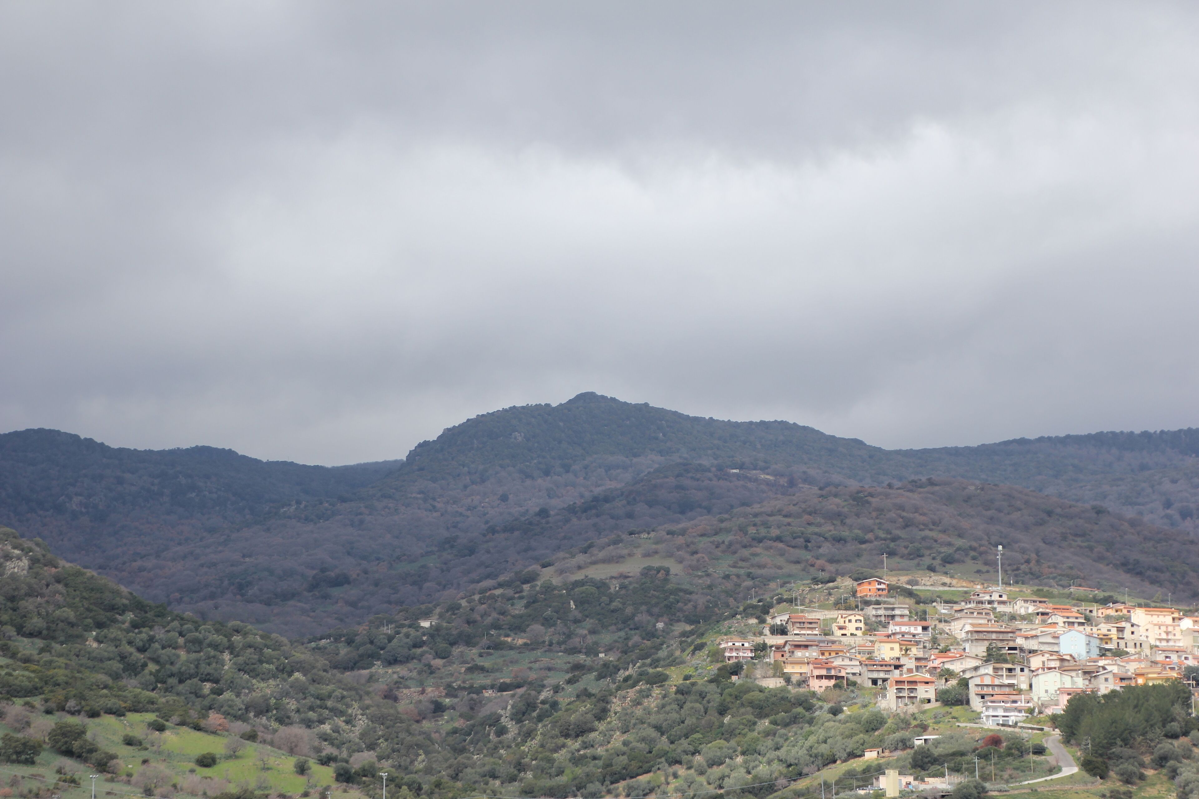 A mountainous landscape with a village nestled in the valley.
