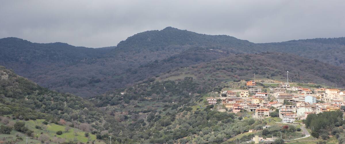 A mountainous landscape with a village nestled in the valley.