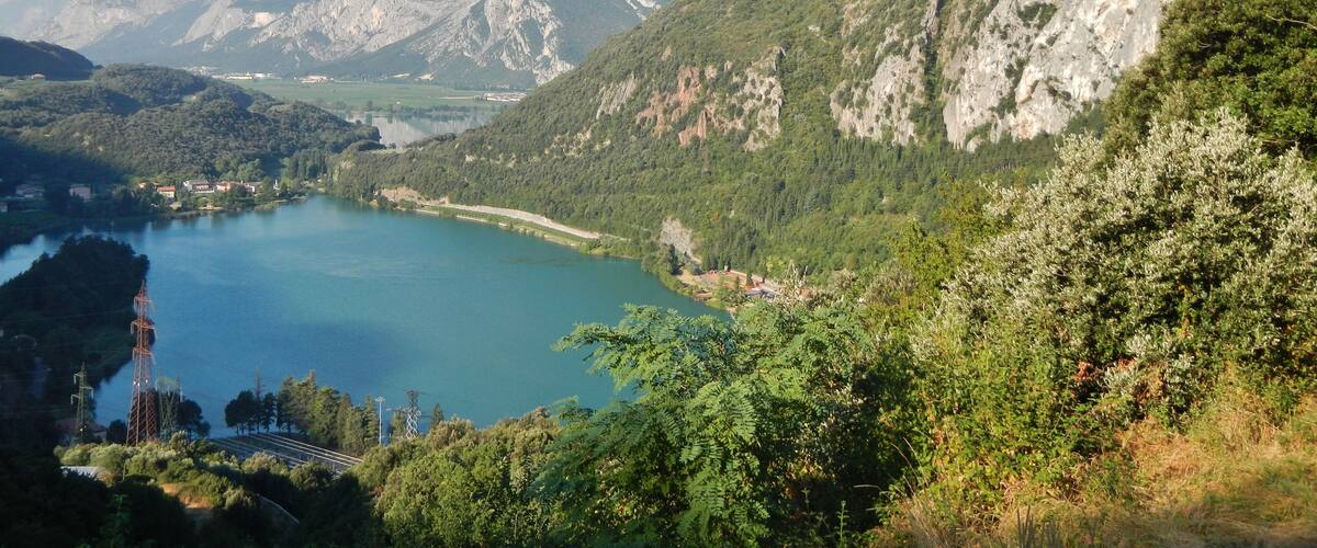 A mountainous landscape with a lake and a small settlement.