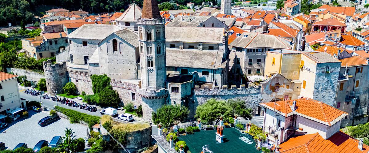 A historic town with a prominent church, castle, and red-roofed buildings.