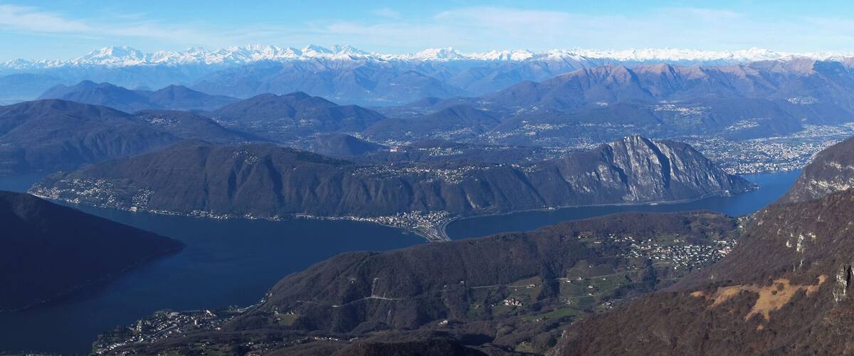 A mountainous landscape with a valley and a lake.