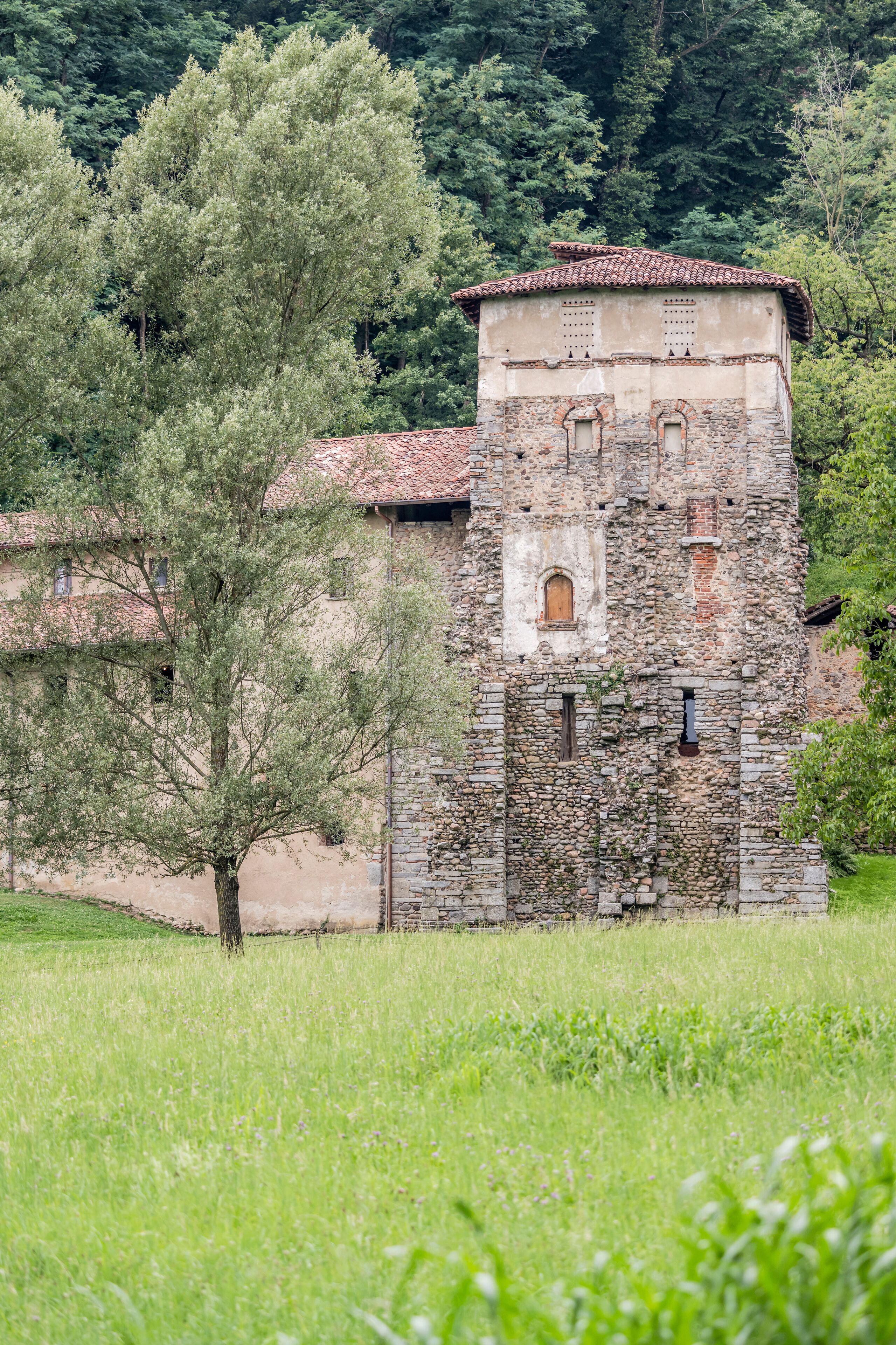 tower of medieval monastery in Olona valley green countryside, Torba, Gornate Olona, Italy