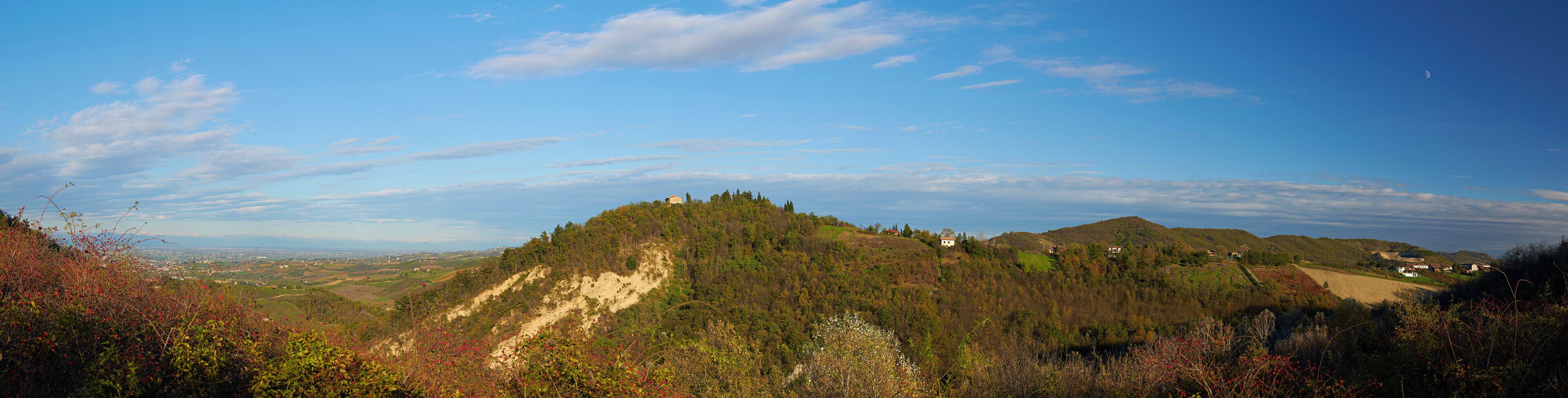 A mountainous landscape with scattered houses and a clear sky.