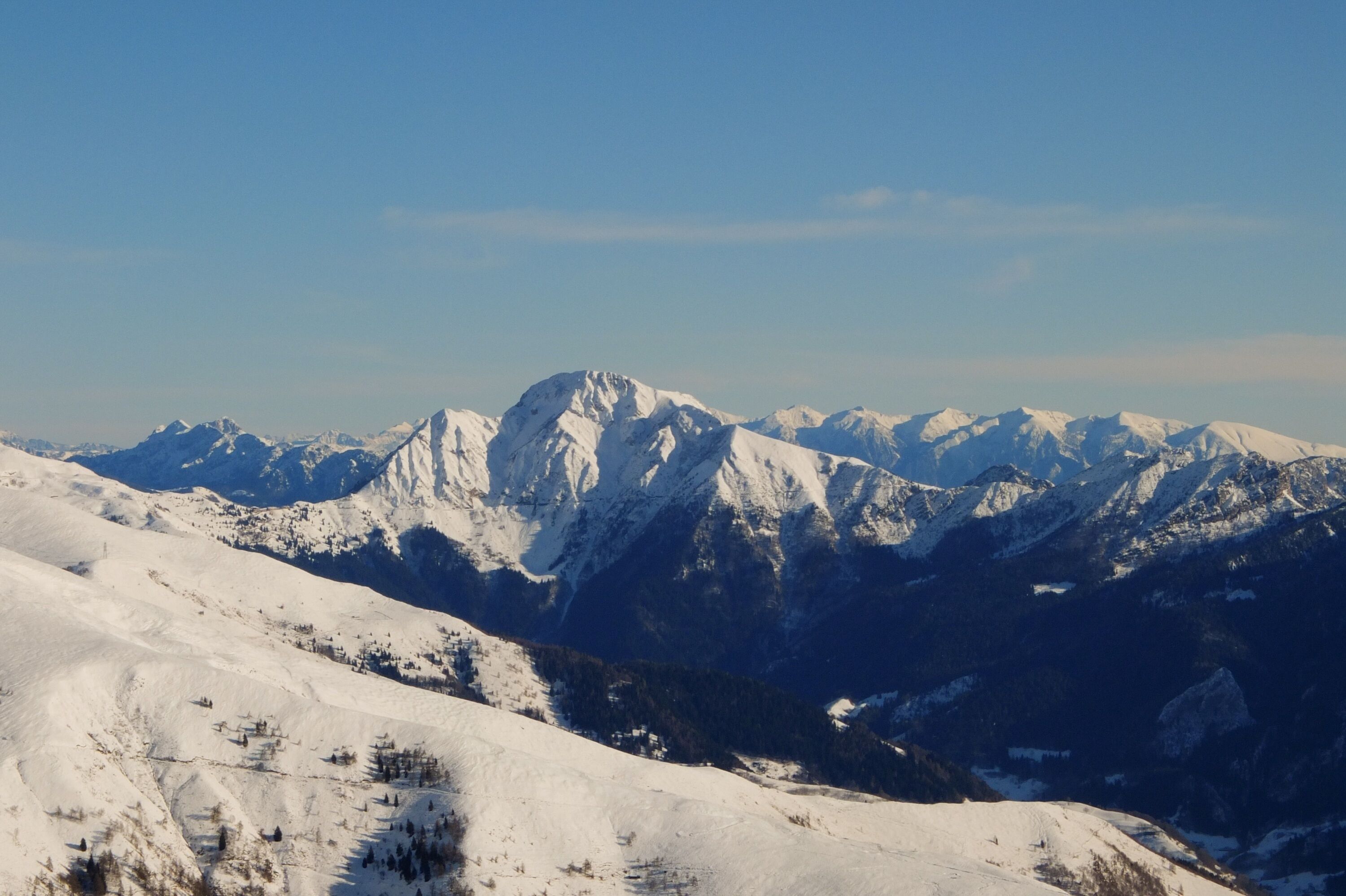 A snow-covered mountain range with clear skies.