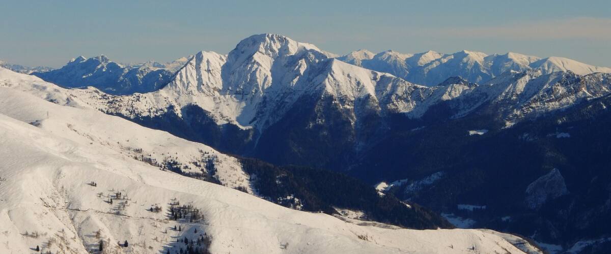 A snow-covered mountain range with clear skies.