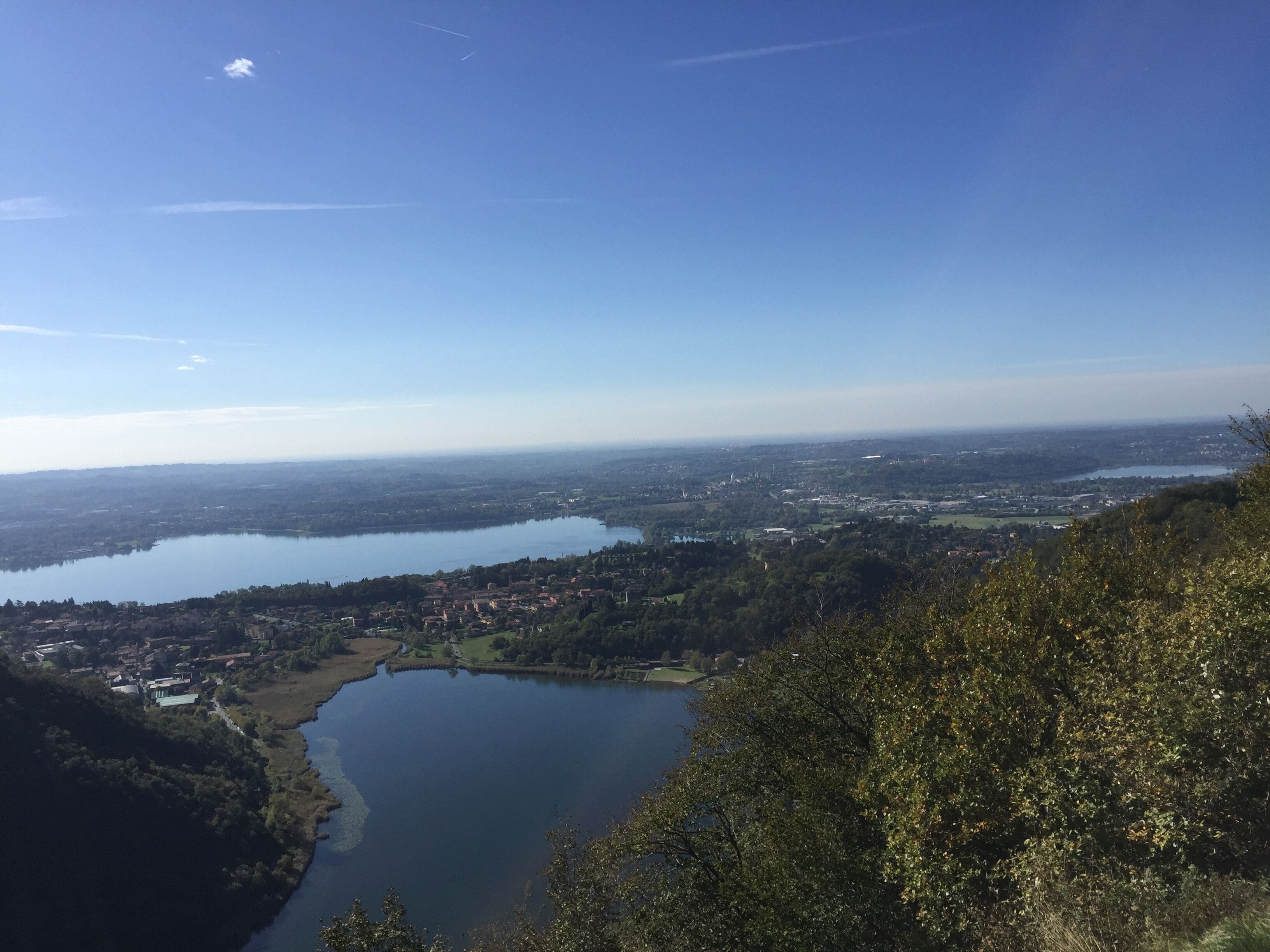 A lake surrounded by hills and a town.