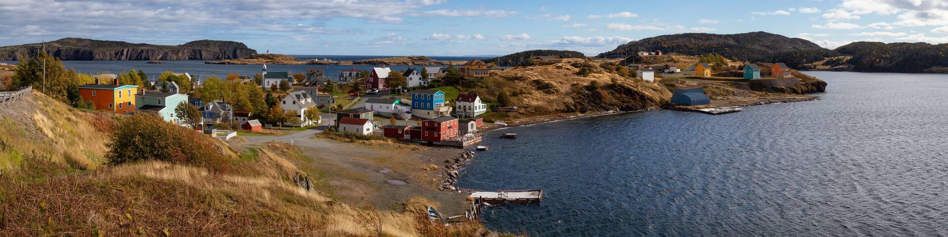 Aerial panoramic view of a small town on the Atlantic Ocean Coast during a sunny day. Taken in Trinity, Newfoundland and Labrador, Canada.