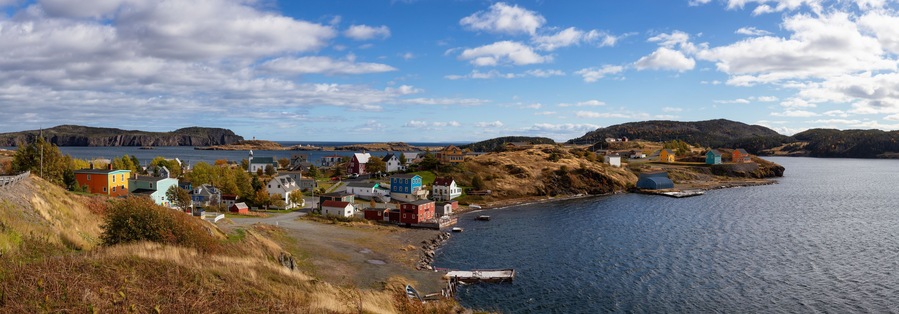 Aerial panoramic view of a small town on the Atlantic Ocean Coast during a sunny day. Taken in Trinity, Newfoundland and Labrador, Canada.