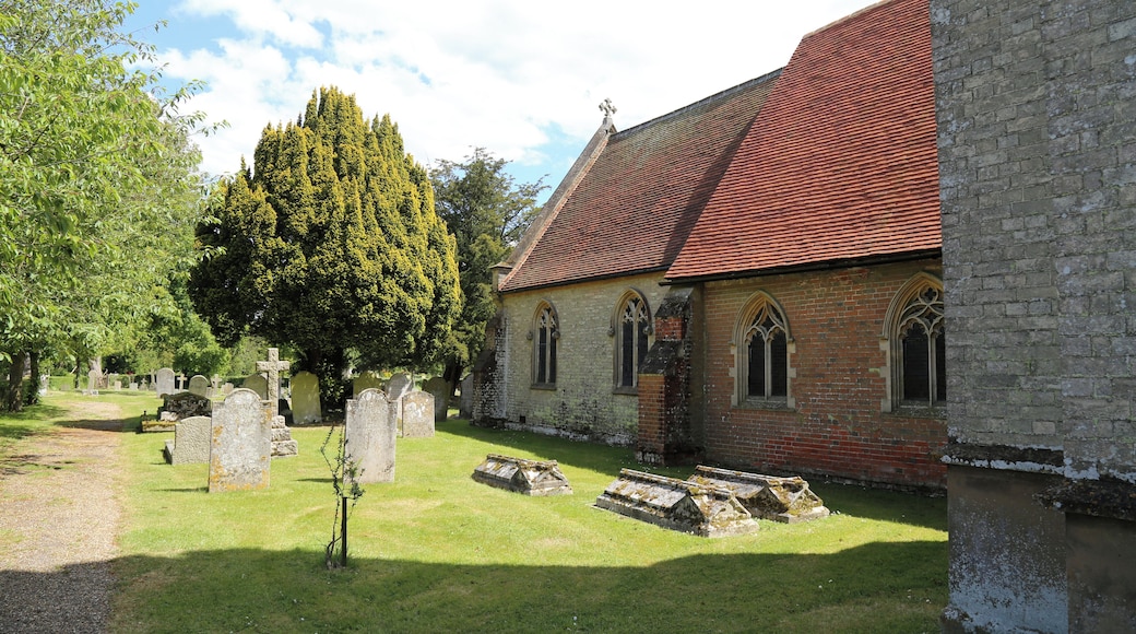 St Germain's Church, Bobbingworth, Essex, England - buttressed nave and chancel, and graveyard with trees, including yew, at the north, looking east from the tower