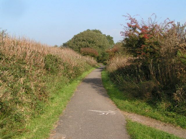 National Cycle Network route 72 In the foreground the Coast-to-Coast long-distance footpath leaves the cyclepath (which follows a disused railway) en route for Cleator (hence "C/C" painted on the tarmac).