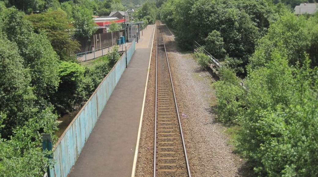 Ton Pentre railway station, Rhondda Cynon Taf Opened in 1861 by the Taff Vale Railway on the line from Cardiff to Treherbert. View south east towards Ystrad Rhondda and Cardiff. However, between 1861 and 1986, it was this station that was known as Ystrad or Ystrad Rhondda. There was formerly a northbound line and platform to the right, even though the section closest to the camera is built over the river (just visible to the left of the blue fencing).