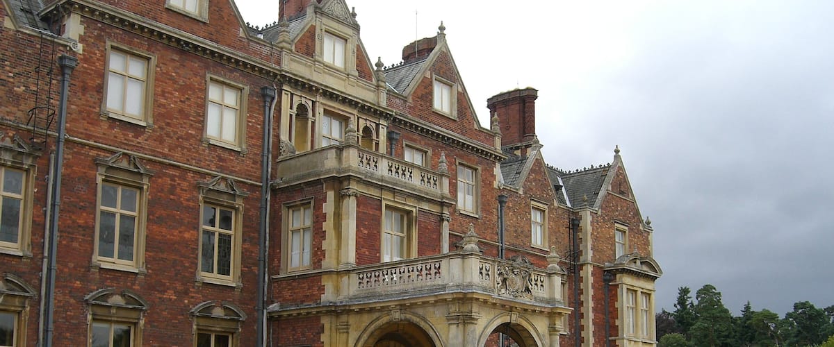 A large, historic building with a prominent entrance and arched doorway.