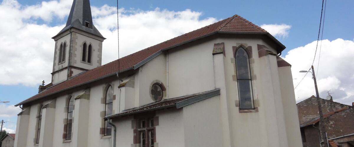 A church with a tall steeple and a bell tower.