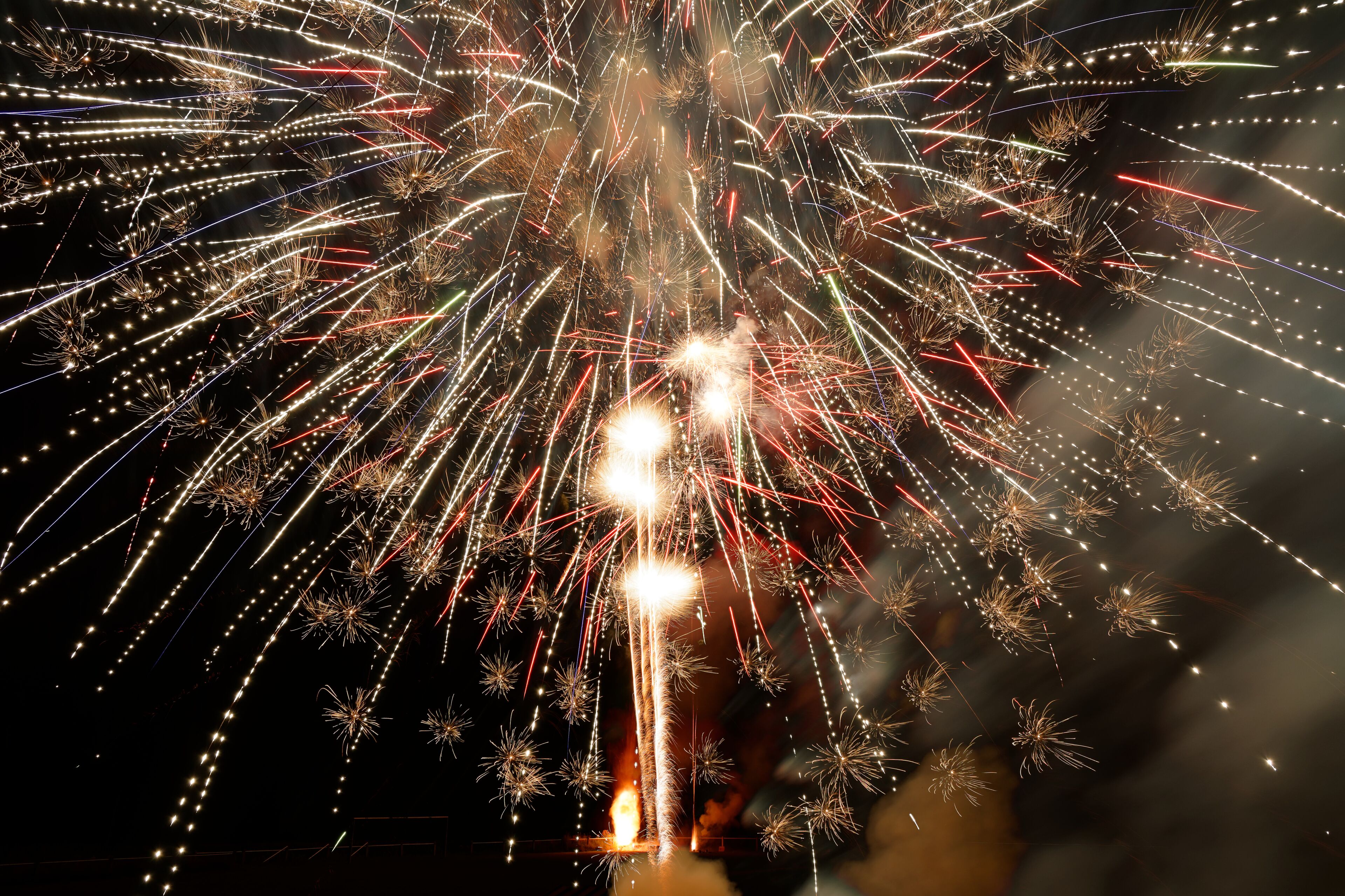 Fireworks exploding in the night sky.