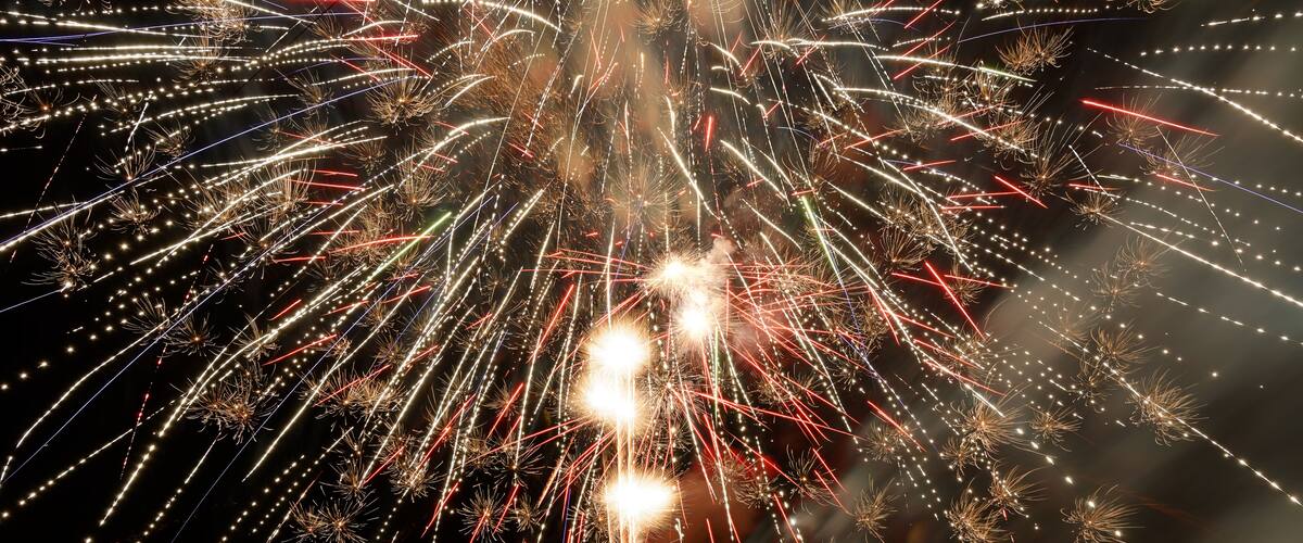 Fireworks exploding in the night sky.
