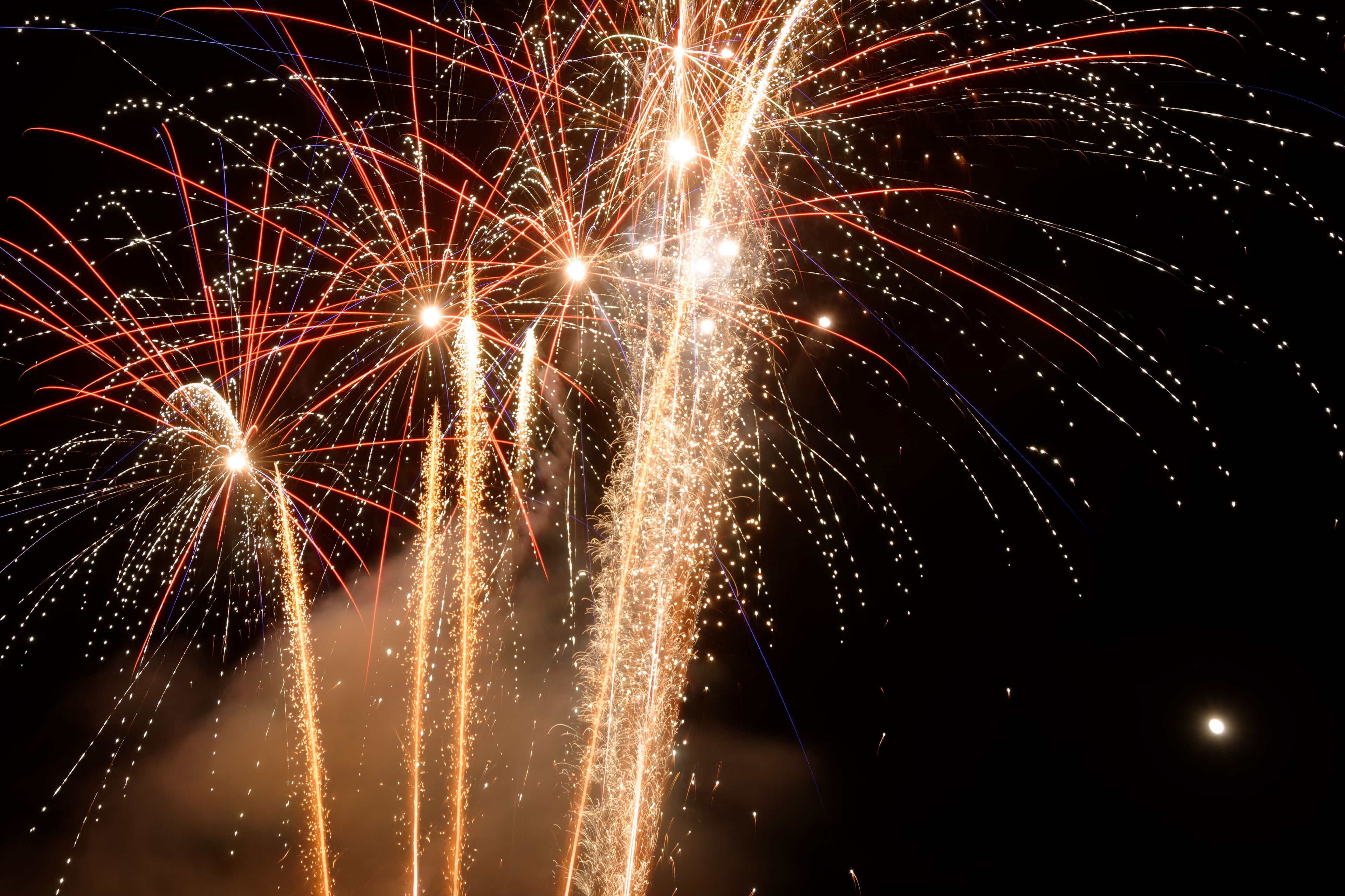 Fireworks exploding in the night sky.