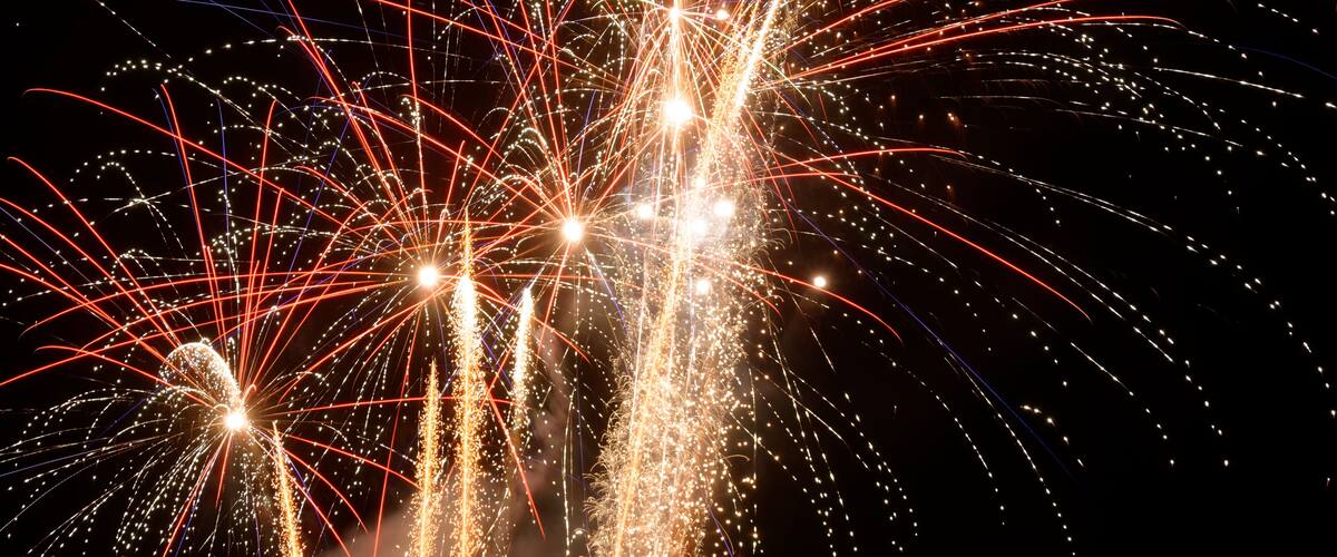 Fireworks exploding in the night sky.
