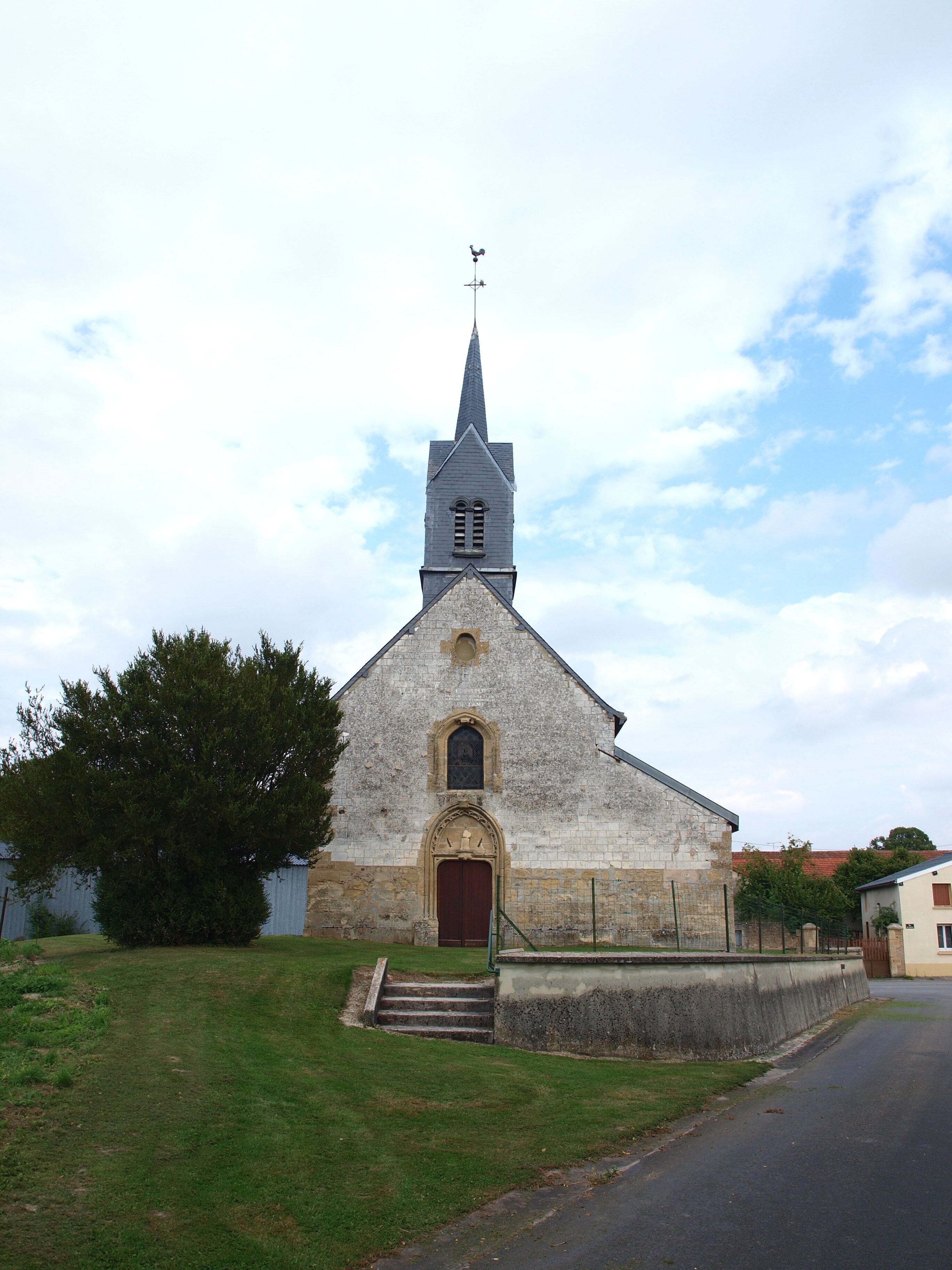 A church with a tall steeple and a weather vane.