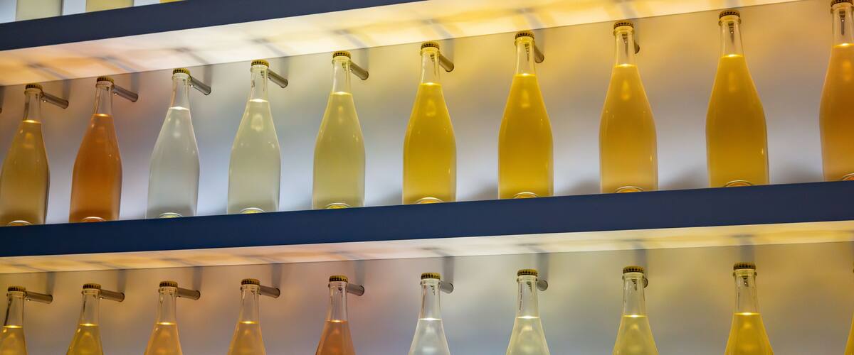 Shelves with various colored bottles.