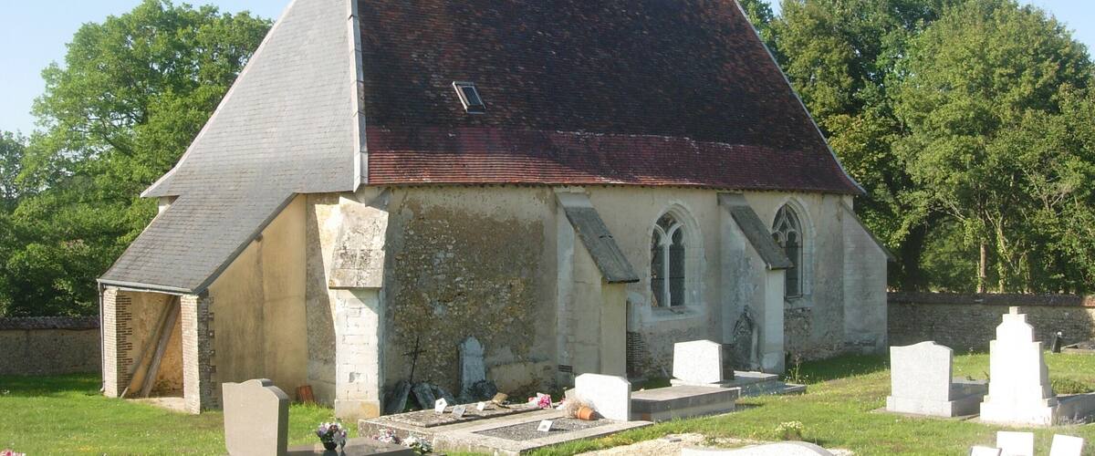 A church with a steeple and a graveyard.