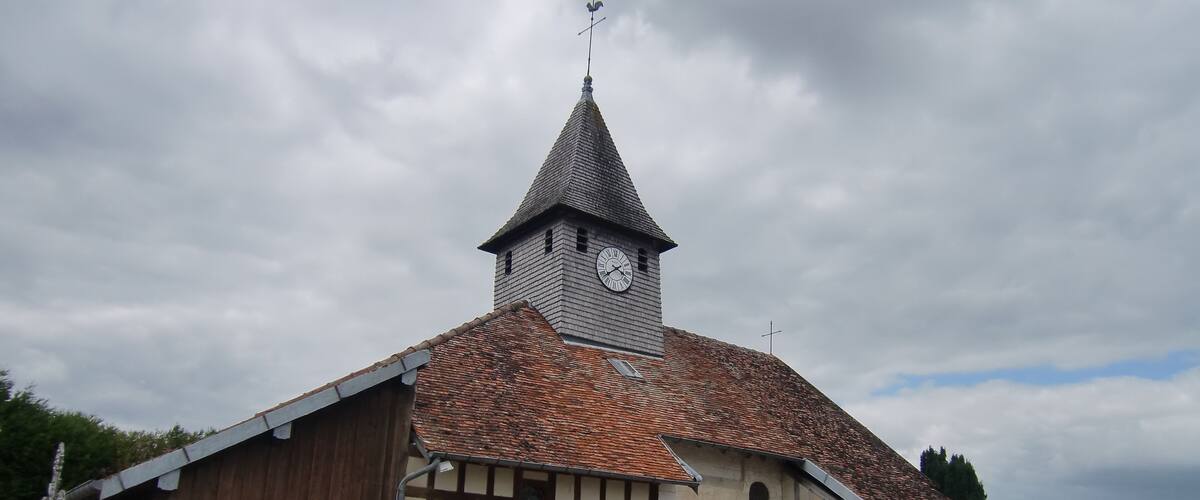 A church with a steeple and a clock.