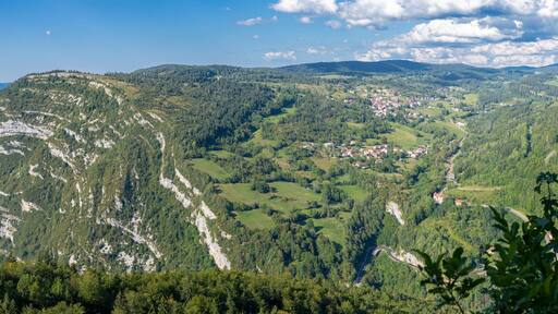 Belvedere La Roche Blanche, France - 09 02 2021: White Rock Belvedere. View of the landscapes of Les Bouchoux with the village Saint Claude, hills, forests and The rocky folds .