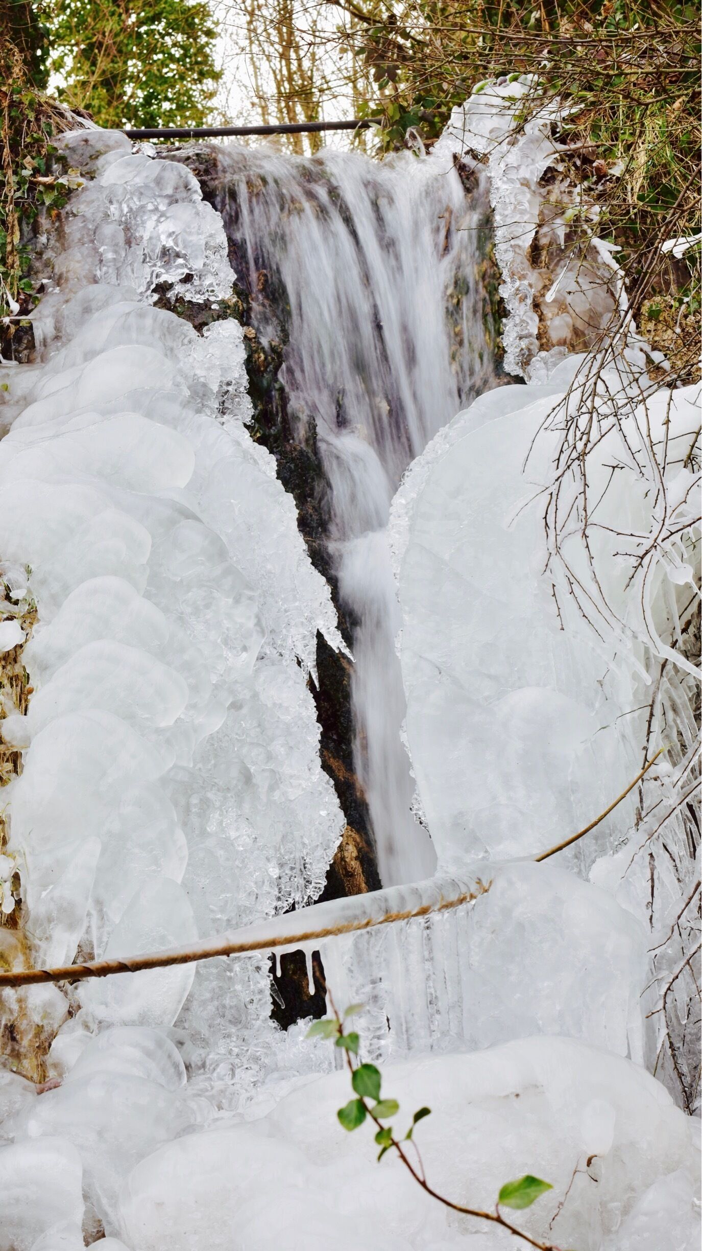 A waterfall partially covered by ice.